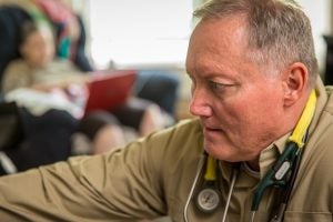 Paramedic Steve Holley provides care to patient in living room in rural Utah during test of new home hospital model 