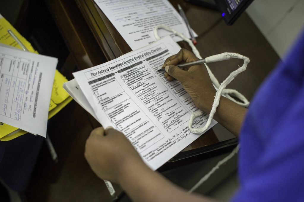 A staff member checks off items on a checklist