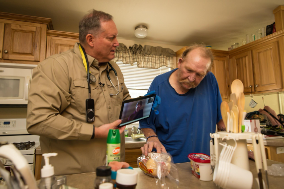 Paramedic Steve Holley reviews nutritional labels with a patient during a mock home hospital admission.