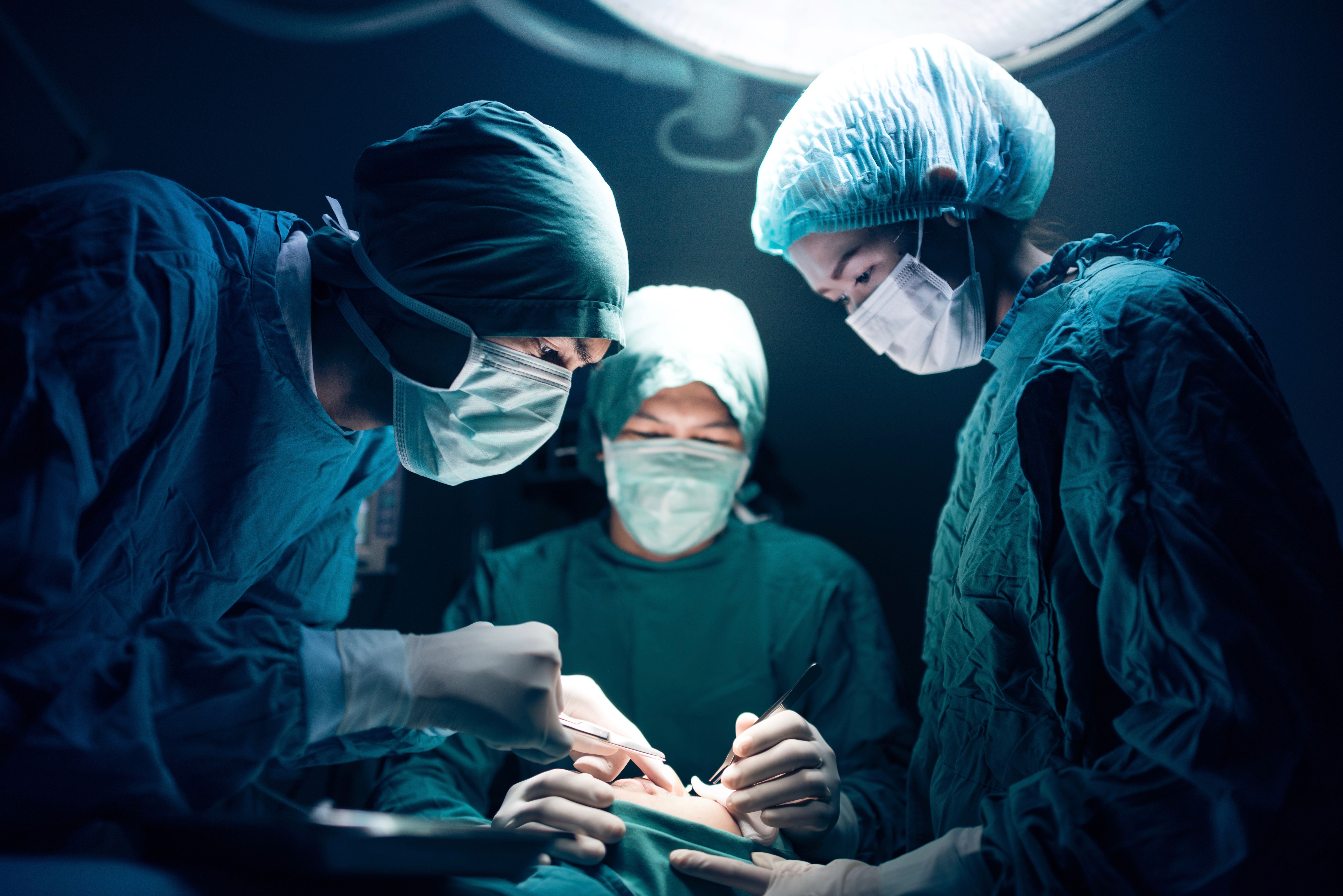 Surgical team working on a patient in operating theater.