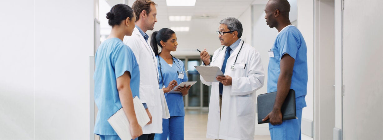 A group of medical practitioners having a discussion in a hospital