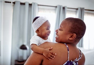 A baby girl bonding with her mother at home