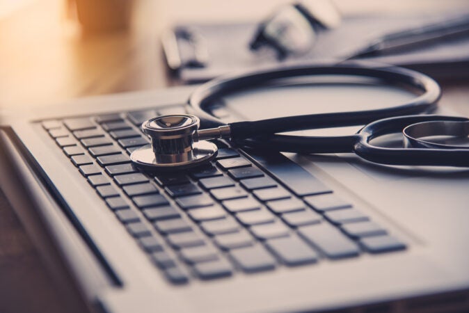 Stethoscope on the keyboard of laptop