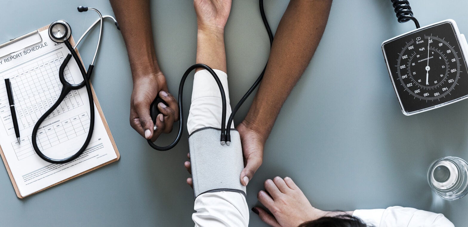 Nurse taking a patient's blood pressure.