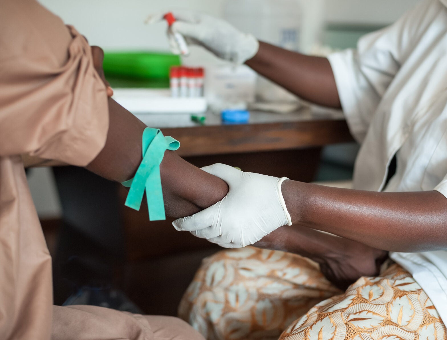 Nurse drawing blood from a patient.