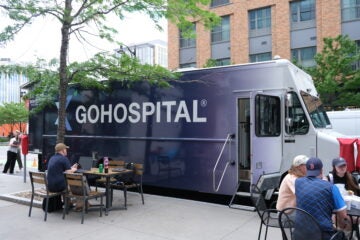 Mobile medical unit parked on the street for guided tours.